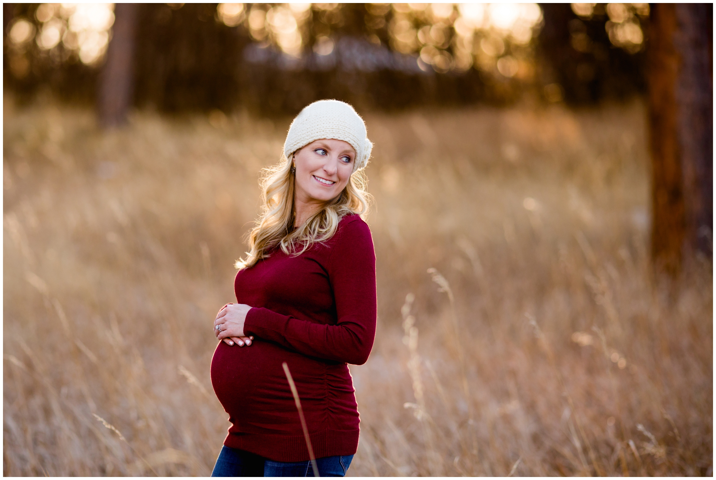 pregnant woman with stocking cap during Colorado winter maternity photography session 