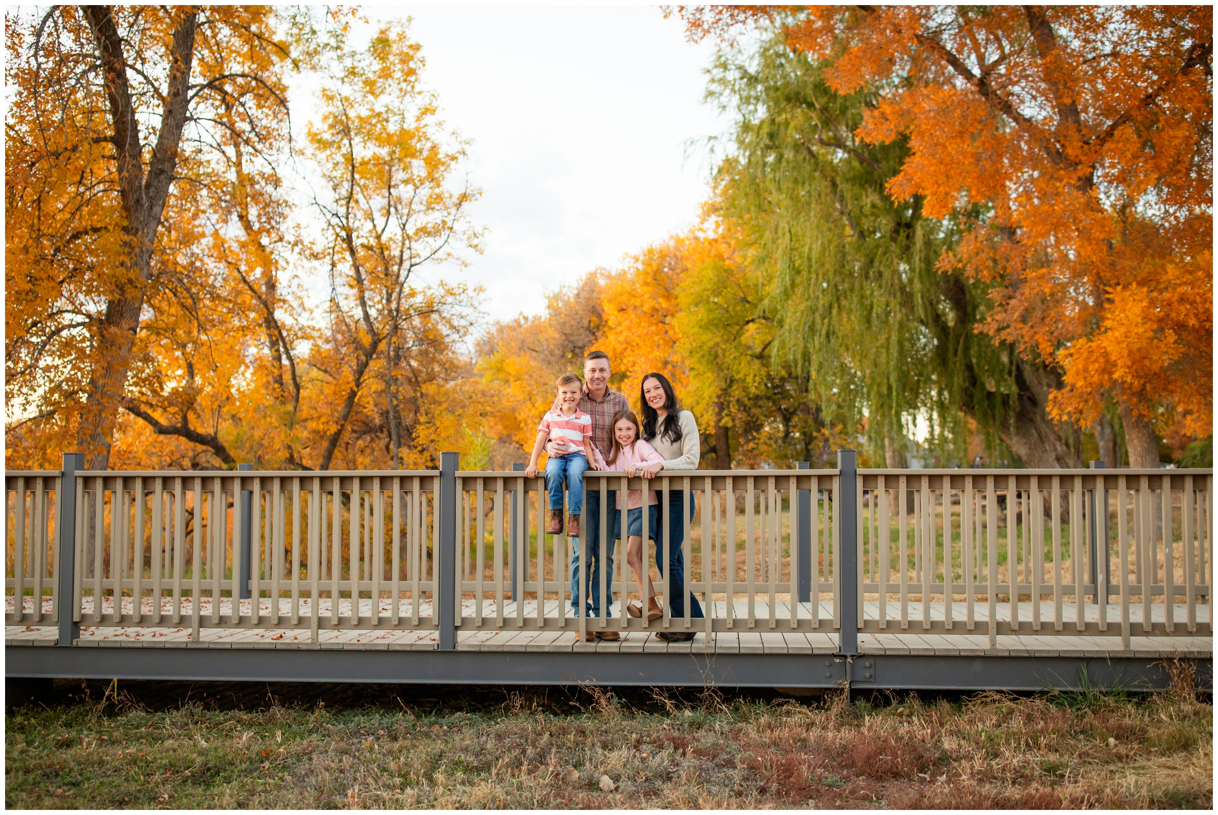 family posing on bridge during fall family pictures in Mead Colorado 