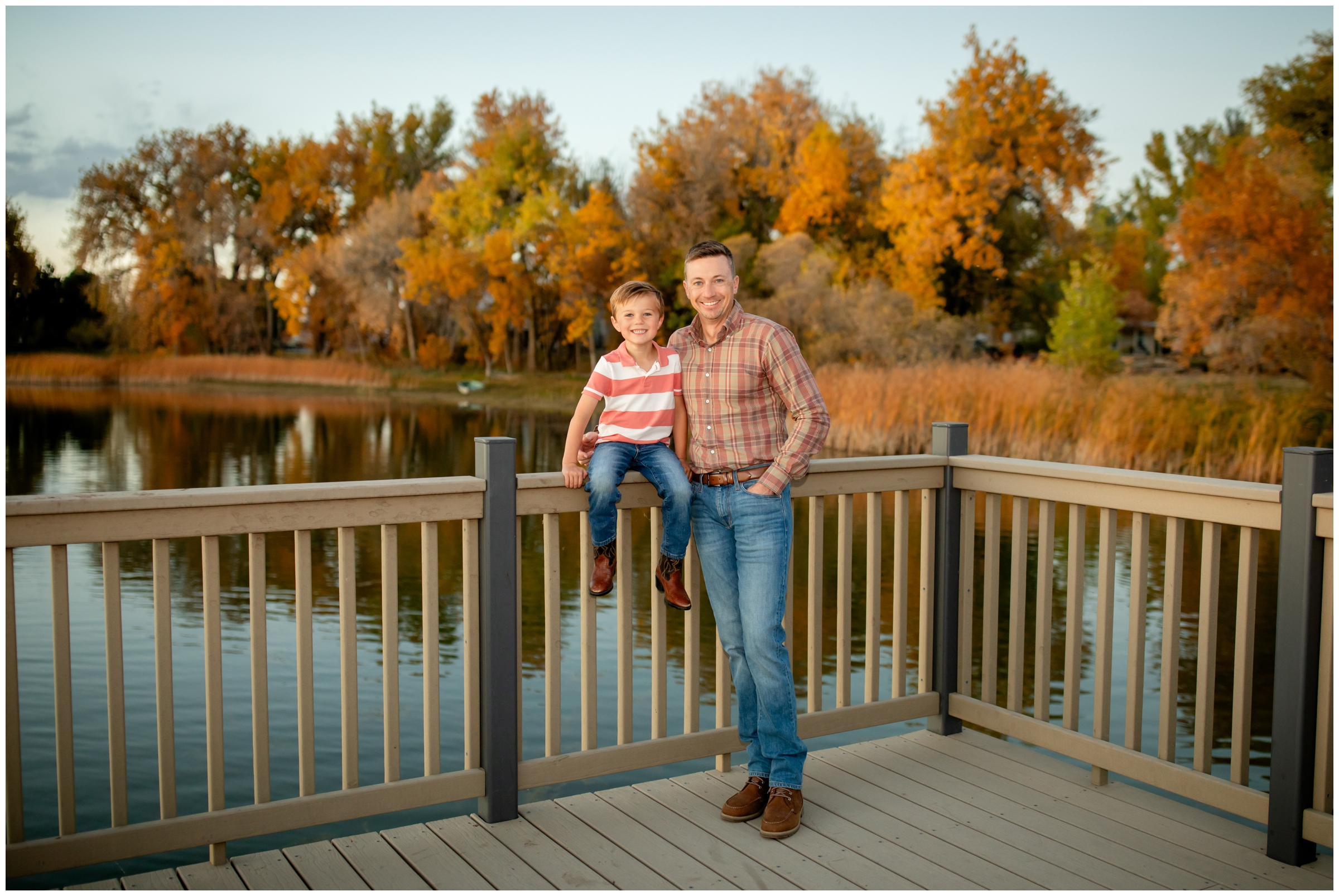 father and son posing on dock of Northern CO lake during fall photography session 