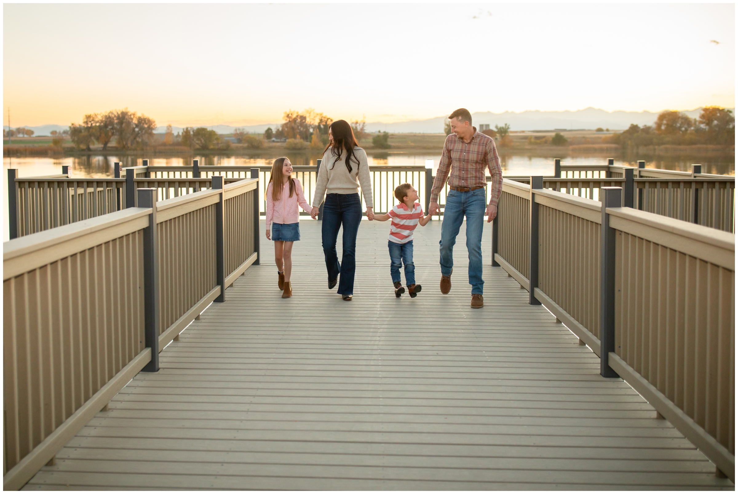 family walking on dock during candid family photography session in Mead Colorado 