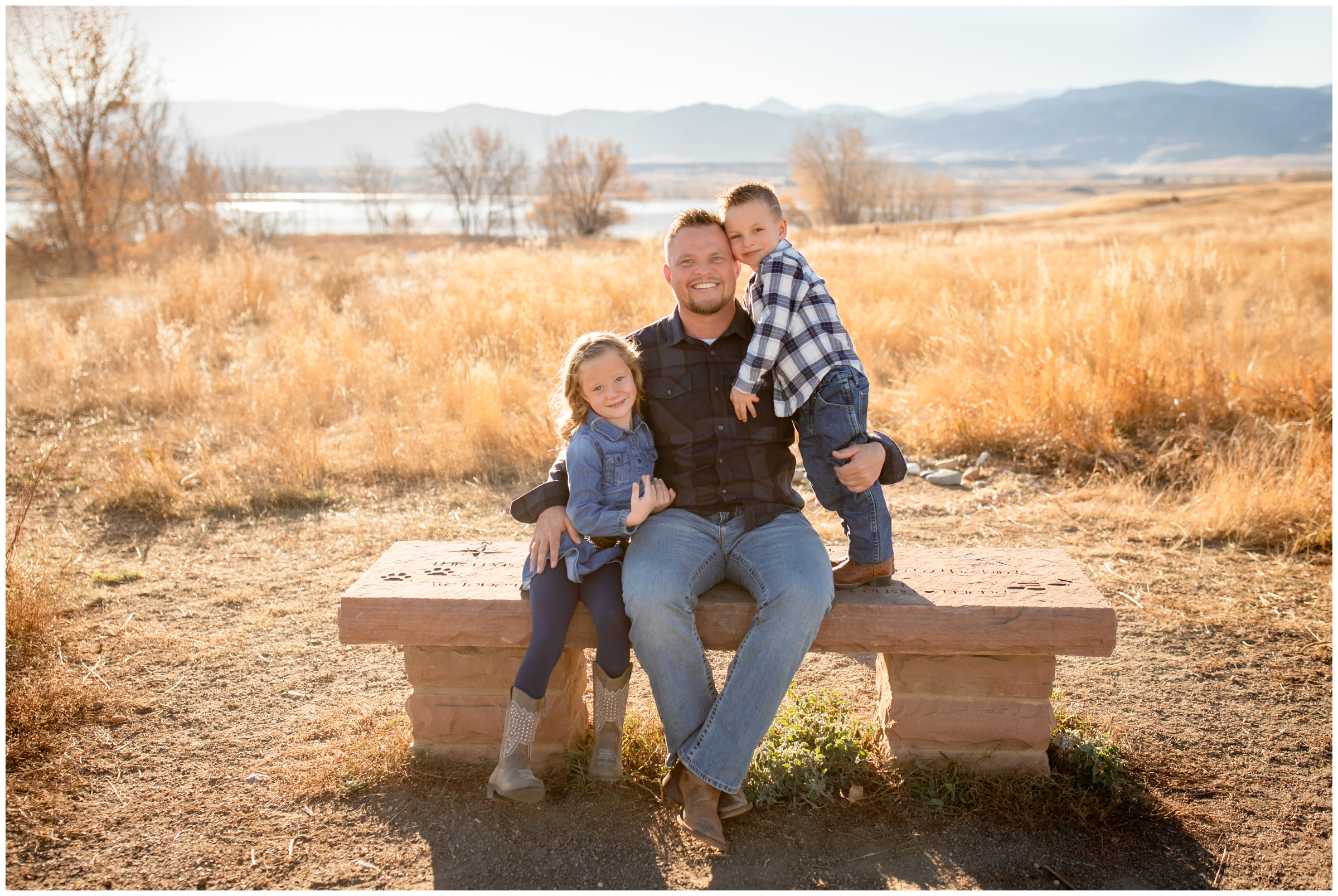 dad and two kids cuddling on a bench during Boulder Colorado family photography session at Coot Lake 