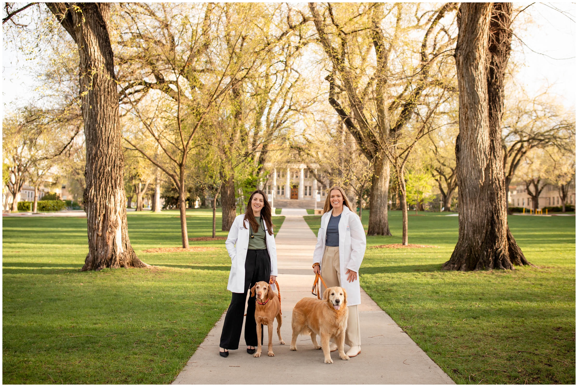 women in doctor white coats during college graduation portraits at the oval at Colorado State University 