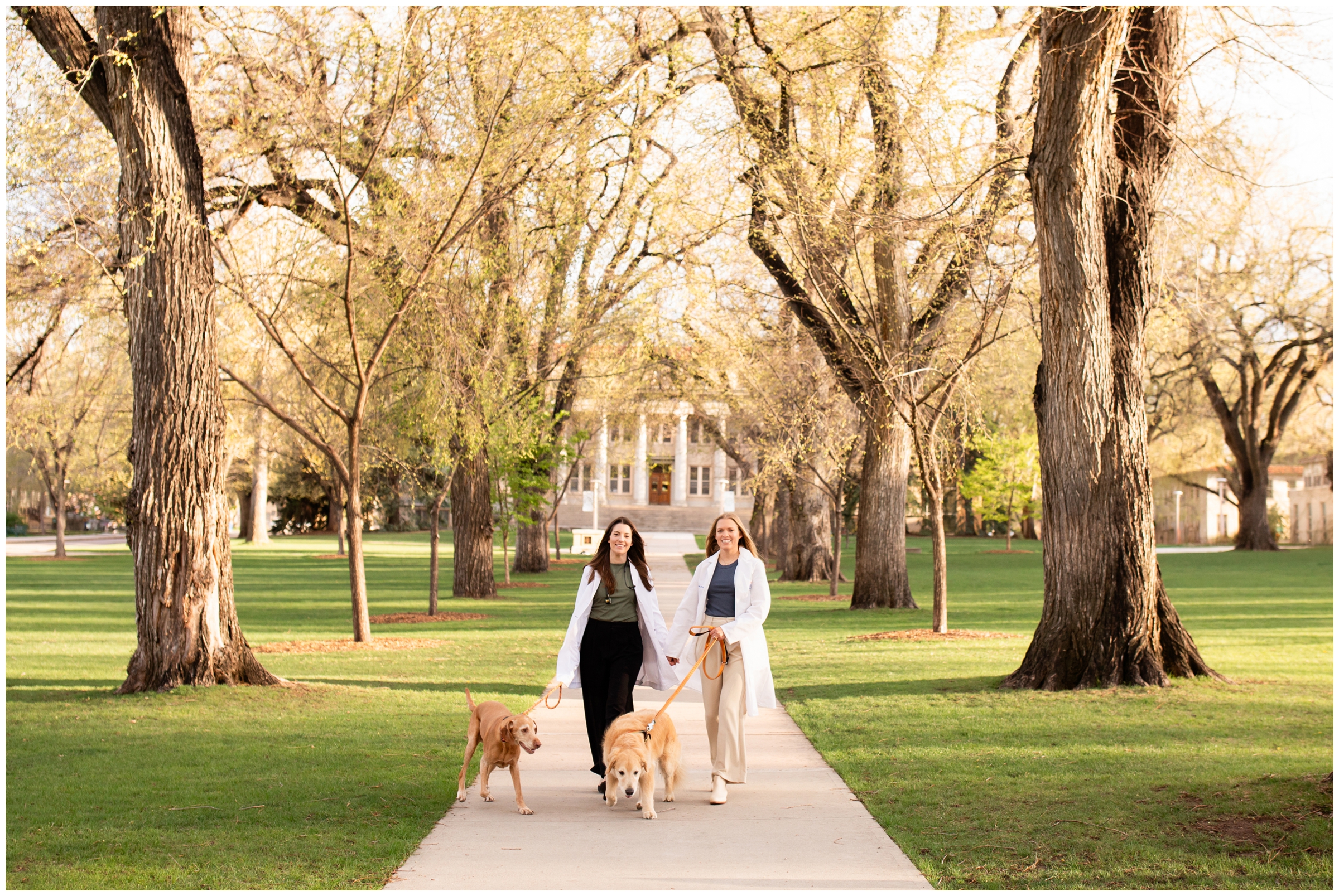 women walking their dogs at the CSU oval during Colorado college senior graduation portraits 